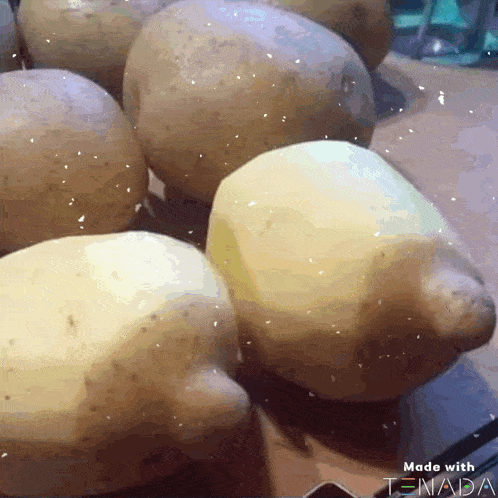 a bunch of potatoes are sitting on a table with the words made with tnada on the bottom right