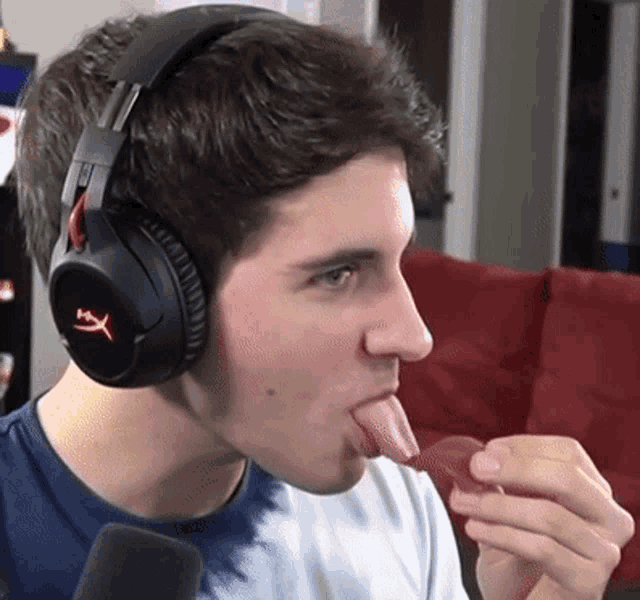 a man wearing headphones has his tongue sticking out