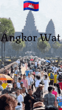 a large group of people are walking in front of a large building with the words angkor wat written above them