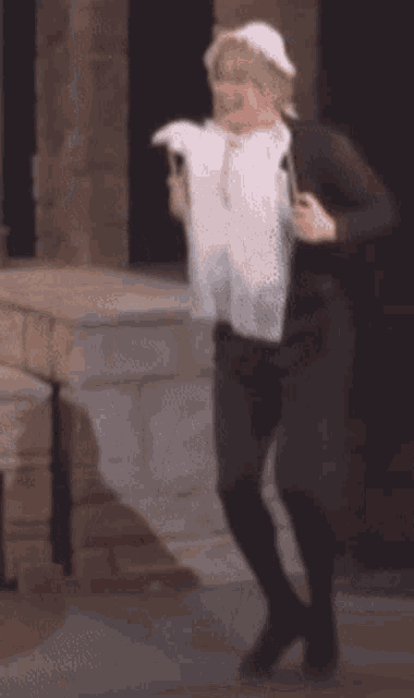 a woman in a white hat is holding a white cloth in her hands