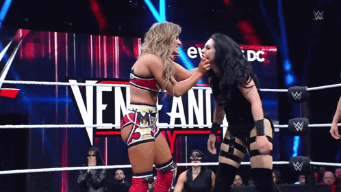two women wrestling in front of a sign that says ' nen lani '
