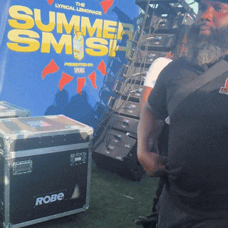 a man stands in front of a summer smash sign