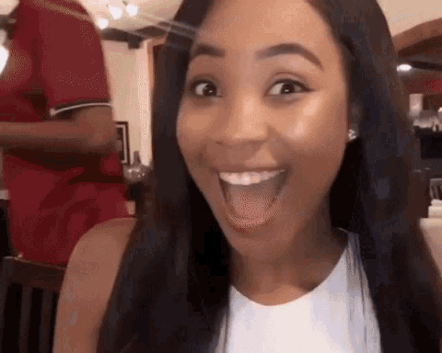 a woman with a surprised look on her face and her mouth open
