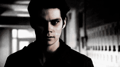 a black and white photo of a young man with a bloody eye .