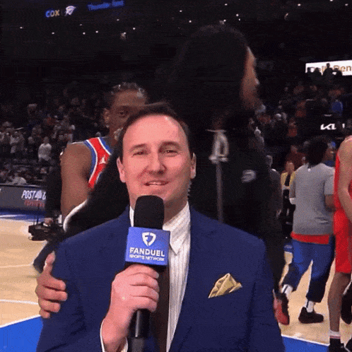 a man with a fanduel sports network microphone