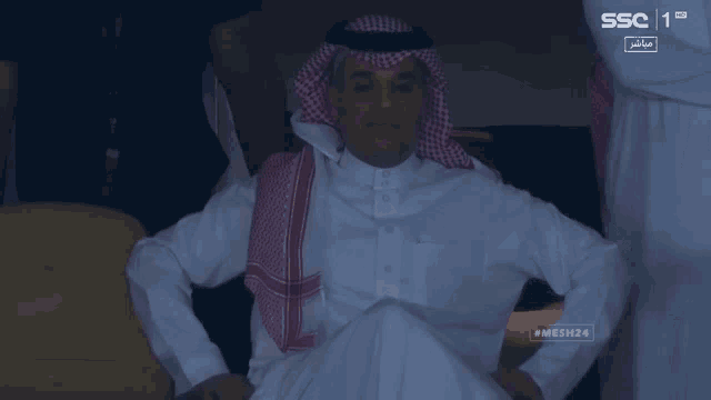 a man in a white shirt sits in front of a screen that says ssc 1 hd