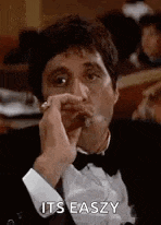 a man in a tuxedo is smoking a cigar and says `` its easy '' .