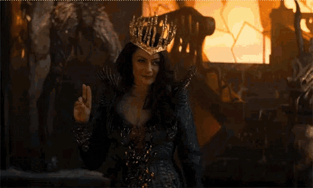a woman wearing a crown and a black dress is standing in a dark room .