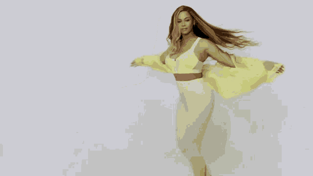 a woman with long hair is wearing a yellow jacket and a white top .