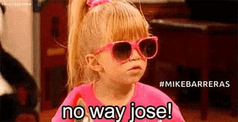a little girl wearing sunglasses and a pink shirt is saying `` no way jose ! ''