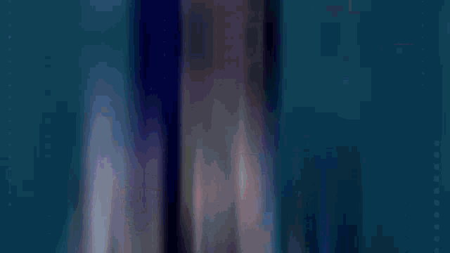 a close up of a person 's face in a video game with blue hair .