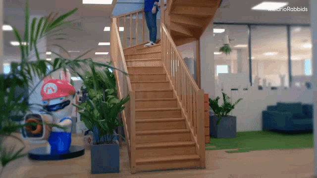 a wooden staircase with a mario rabbit statue behind it