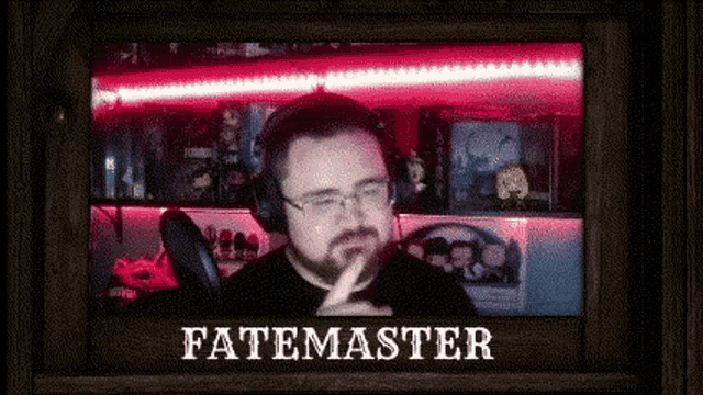 a man wearing headphones and glasses is talking into a microphone in front of a red light .