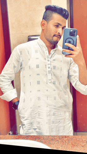 a man in a white shirt takes a selfie with his iphone