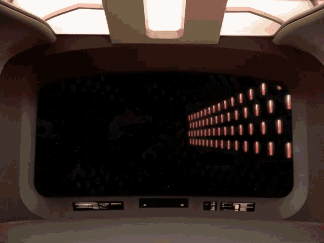 a room with a large screen and a few buttons