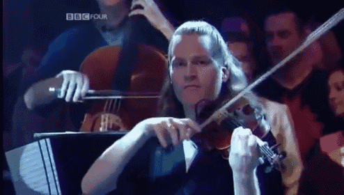 a woman is playing a violin in front of a bbc four sign