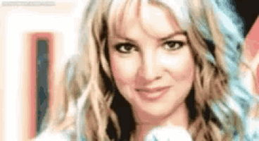a close up of a woman 's face with long blonde hair and blue hair .
