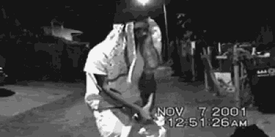 a black and white photo of a man dancing with the date nov 7 2001 at the bottom