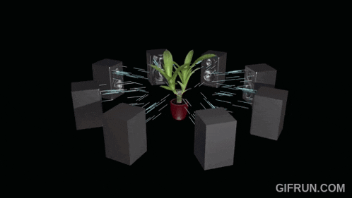 a plant in a pot is surrounded by speakers and a gif run.com logo