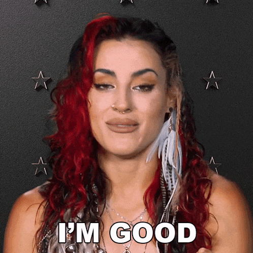 a woman with red hair says i 'm good in front of a black background