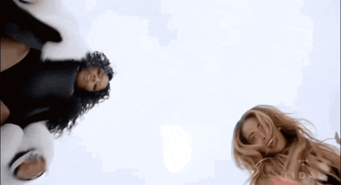 two women are standing next to each other and the word tidal is on the bottom