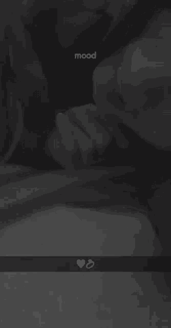 a black and white photo of a man and woman kissing with the words mood written on the bottom