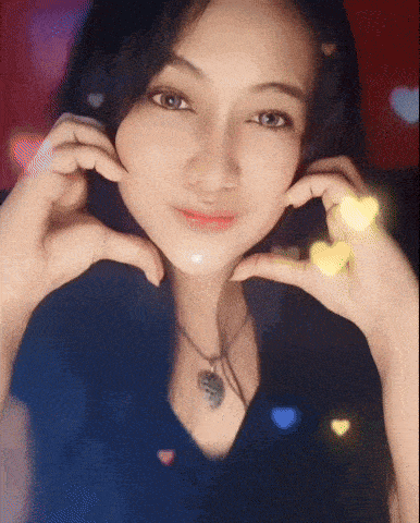 a woman making a heart with her hands