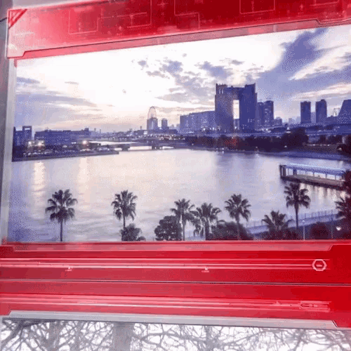 a picture of a body of water with palm trees and buildings in the background