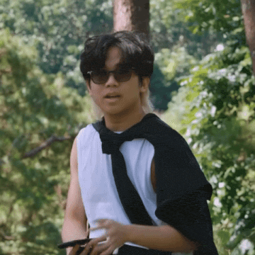 a man wearing sunglasses and a black scarf around his shoulder