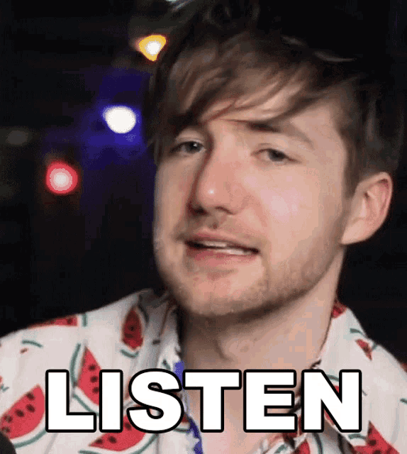 a man wearing a watermelon shirt says listen on his face