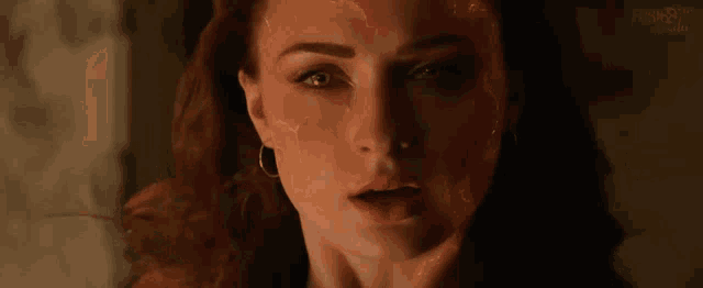 a close up of a woman 's face with lightning coming out of it .