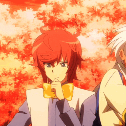 a boy with red hair has a yellow bow tie
