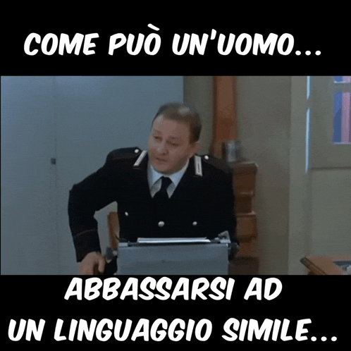 a man in a military uniform is sitting at a desk with a laptop and the caption come puo un'uomo