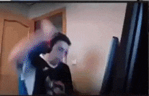 a blurry picture of a man looking at a computer monitor