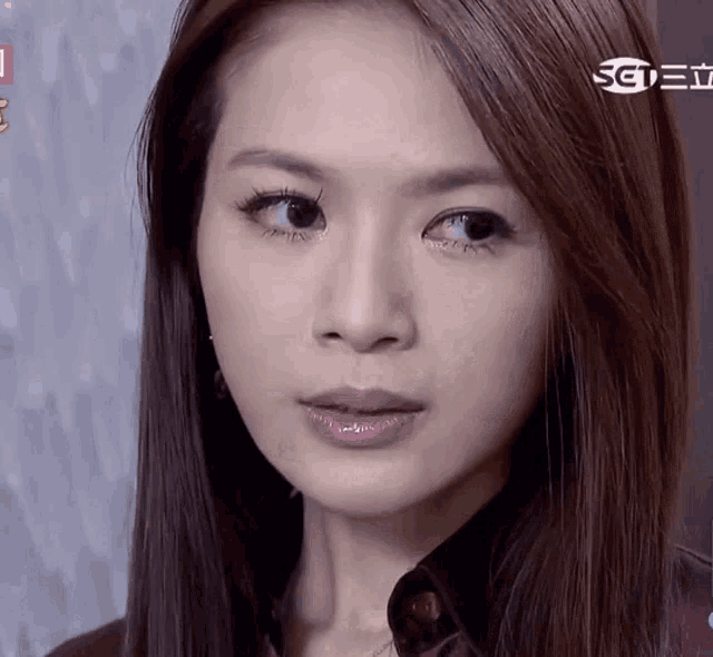 a close up of a woman 's face with the letters sctv on the bottom