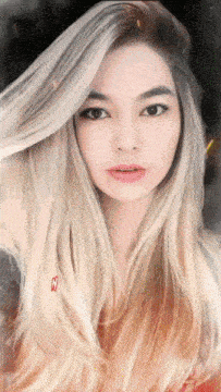 a painting of a woman with long blonde hair has the letter m on the bottom right corner
