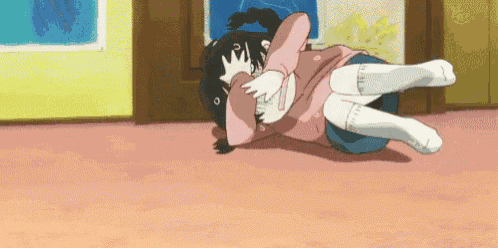 a girl in a pink dress is laying on a man 's lap in a room .