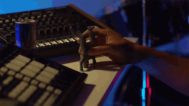 a can of red bull is on a table next to a keyboard