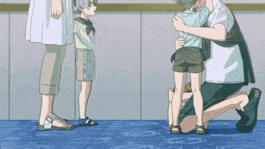 a man is kneeling down and hugging a young boy