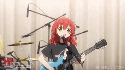 a girl with red hair singing into a microphone while holding a guitar