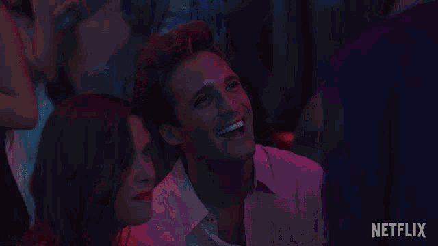 a man and woman are looking at each other and the man is smiling and says " que "