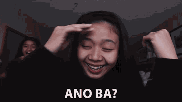 a girl with red lipstick is smiling with the words ano ba on the bottom right