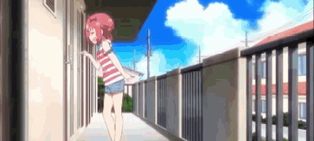 a girl with pink hair is standing in a hallway next to a building .