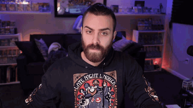 a man with a beard is wearing a hoodie that says late night lindler