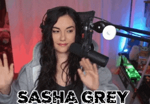 a woman standing in front of a microphone with the name sasha grey written on the bottom
