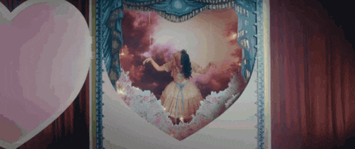 a picture of a woman in a dress in a heart shaped box