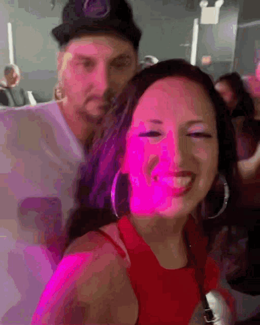 a man and woman are posing for a picture in a club