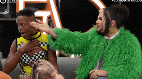 a man in a green fur coat is talking to another man