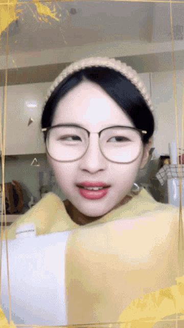 a woman wearing glasses and a knitted headband