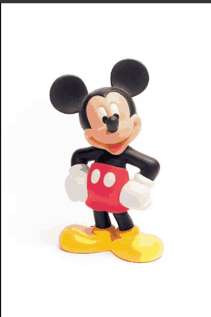 a mickey mouse figurine with red shorts and yellow feet